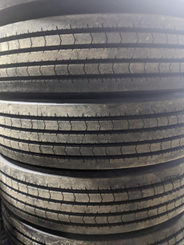 Closeup of truck tires stacked on top of one-another. The emphasis is on the tread design. These commercial truck tires are available at CFI Tire Service  in Glenwood and Council Bluffs, IA